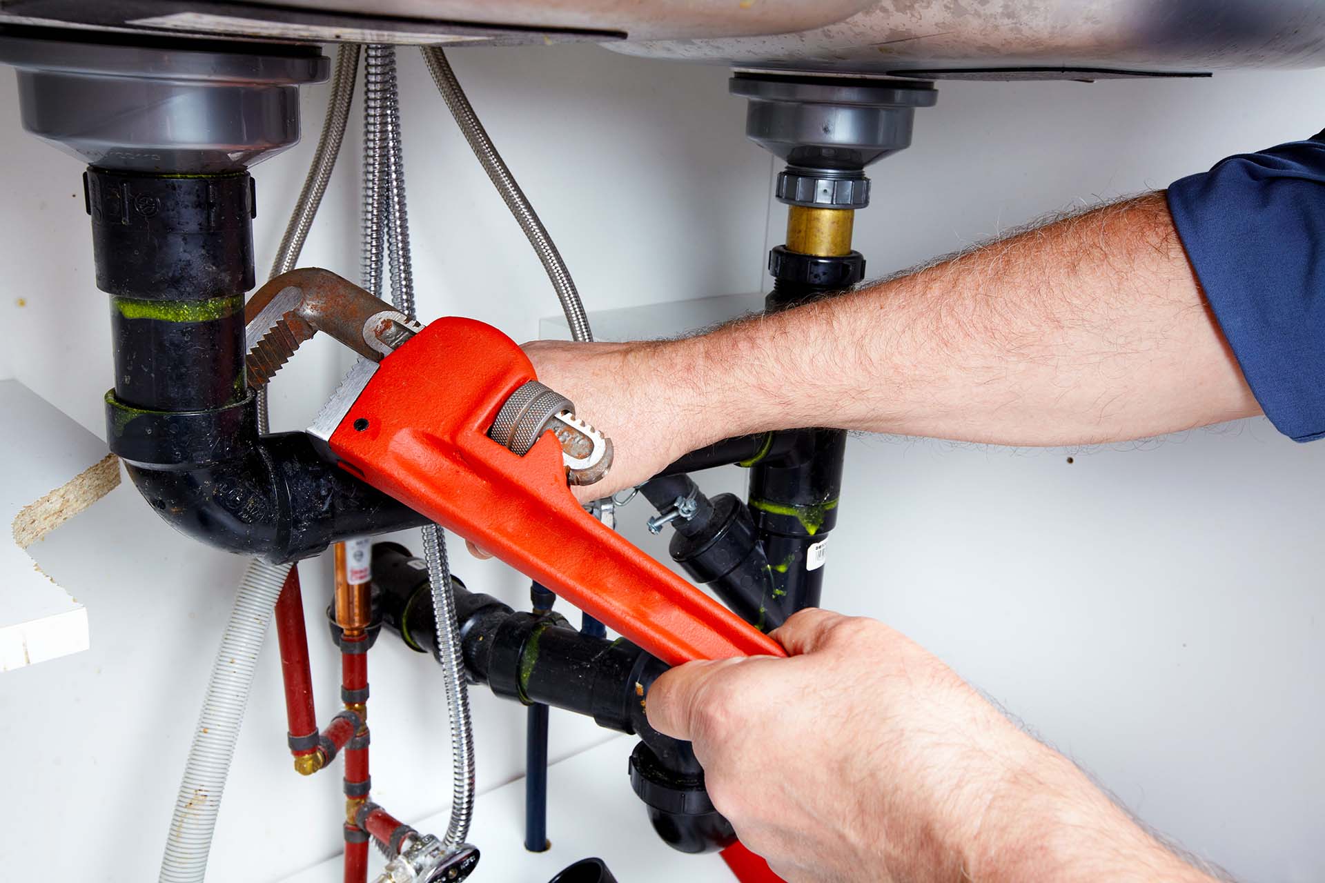 Plumber Fixing Clogged Sink