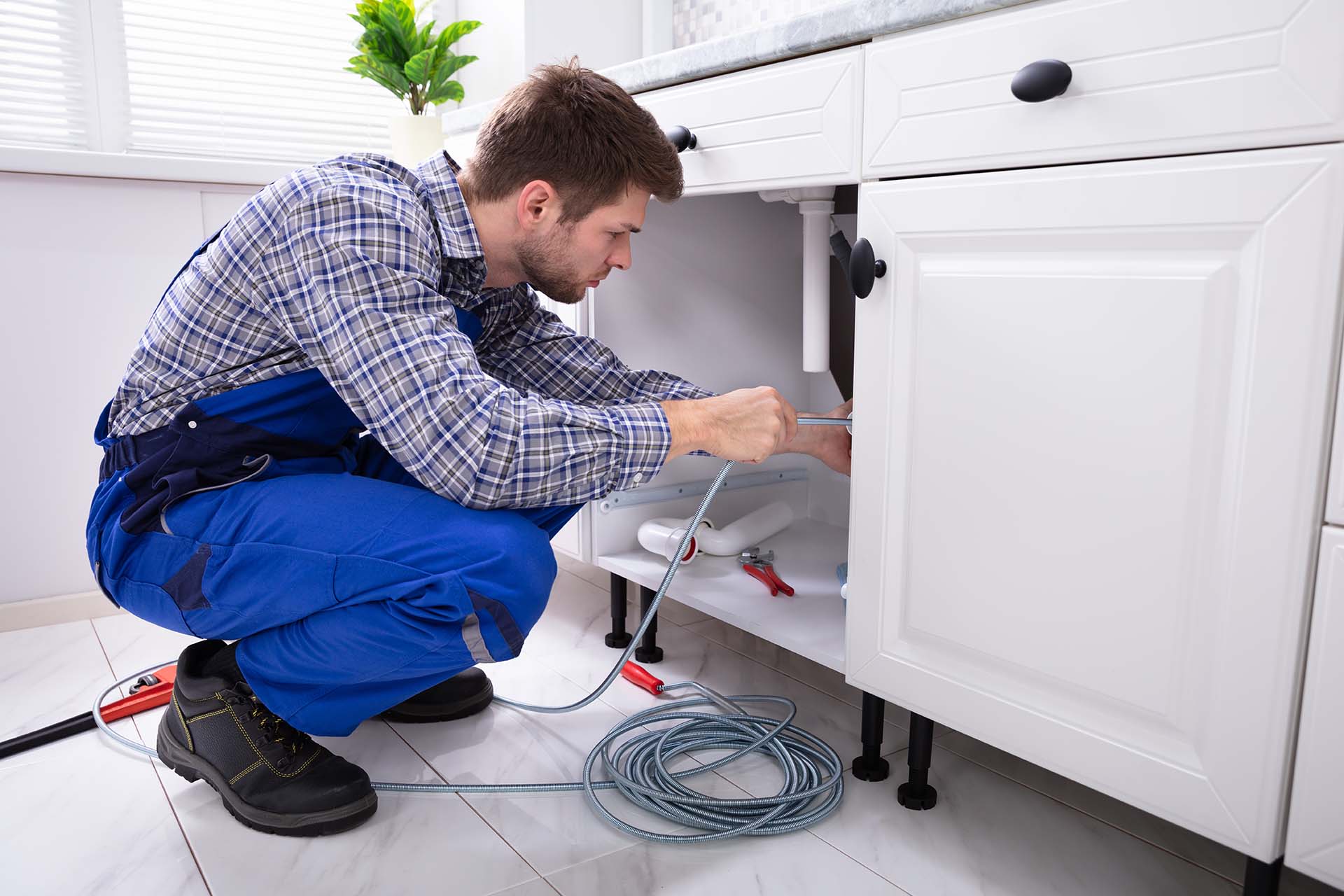 Plumber Cleaning Drain