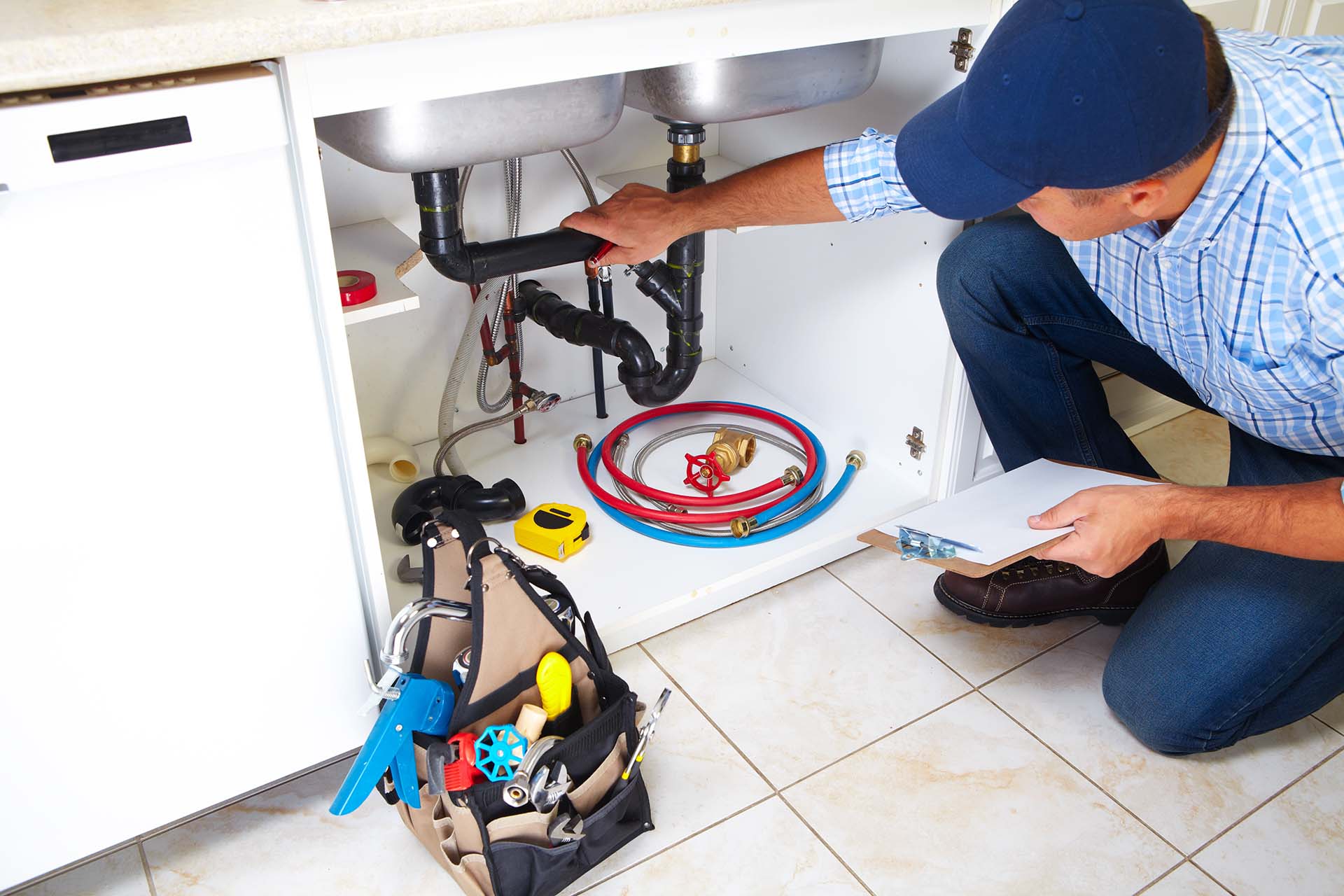 Plumber Fixing Clogged Sink